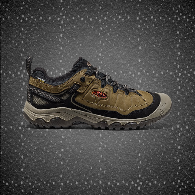Men's brown, tan and black leather hiking shoe featuring a leather and waterproof exterior and a rugged sole.