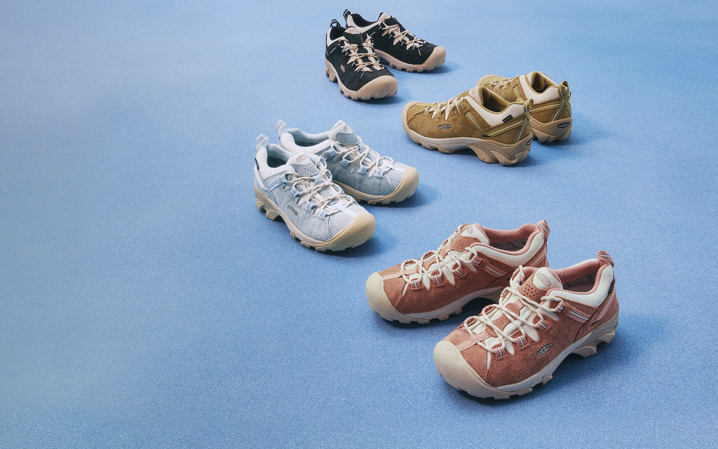 4 different  pairs and colors of the Targhee II shoe in suede against a blue background. 