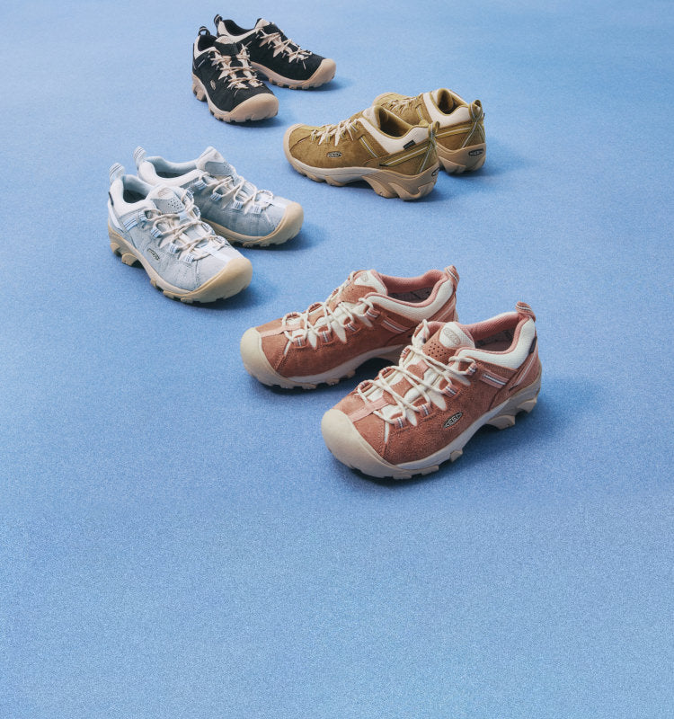 4 different  pairs and colors of the Targhee II shoe in suede against a blue background. 