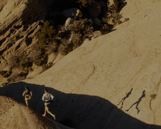 925 durability logo embedded over blurred image of two trail runners.