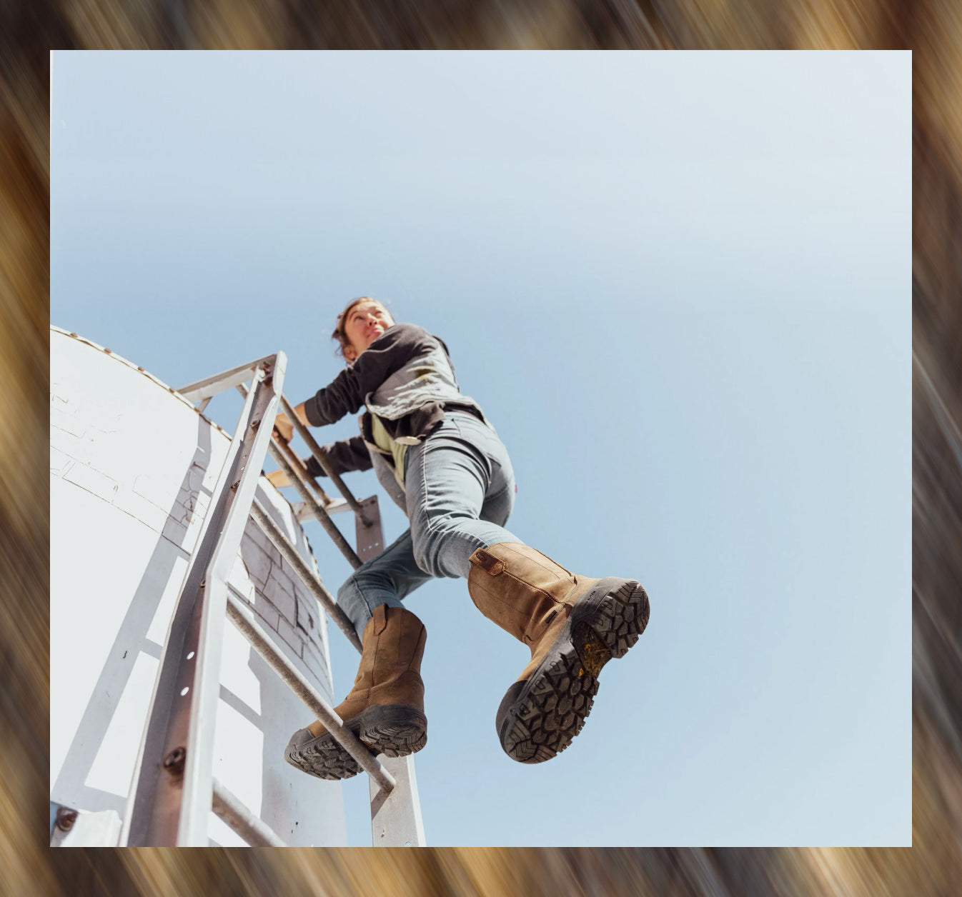 A woman climbing a ladder while wearing the brown Evanston pull-on waterproof work boot, showcasing the ultra tough tread and protective outsole.