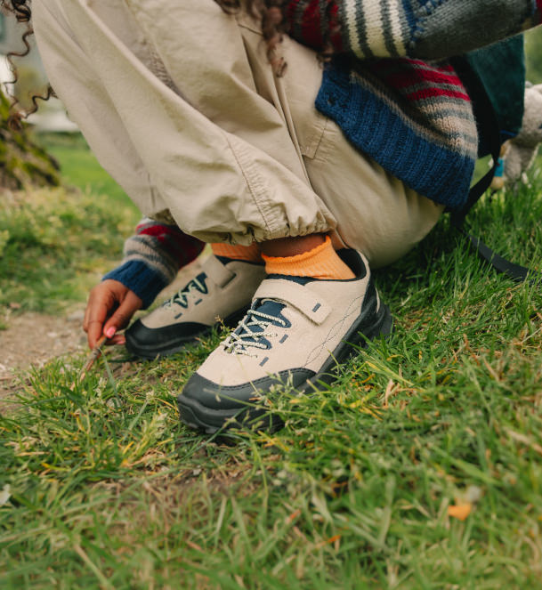 kid wearing jasper sneakers on grass. 