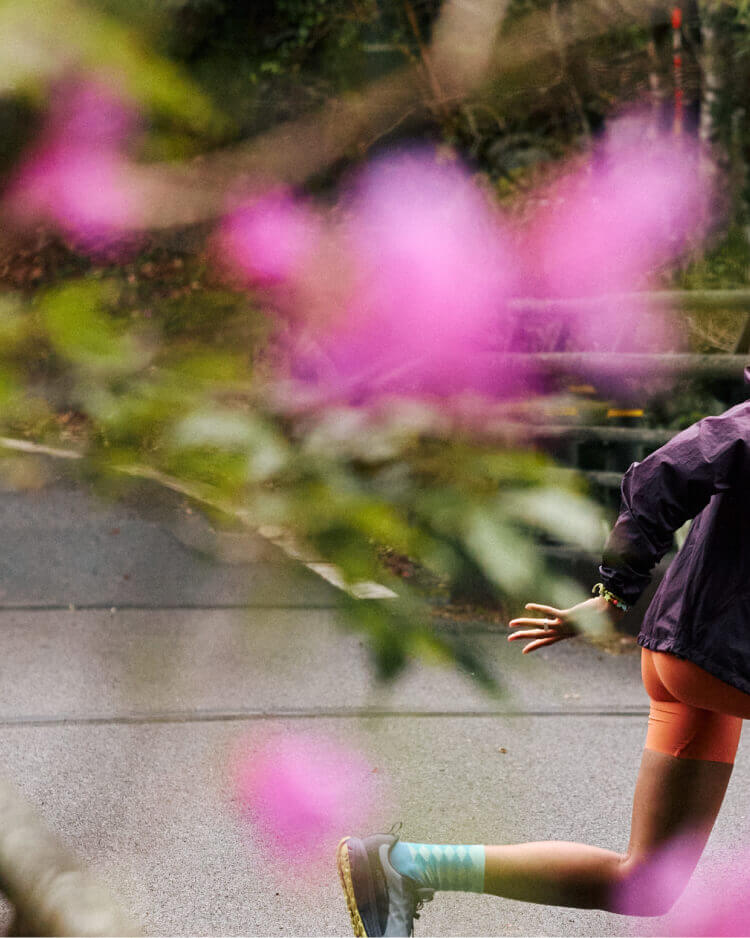 Woman doing lunges on paged bridge while wearing KEEN Roam running shoes