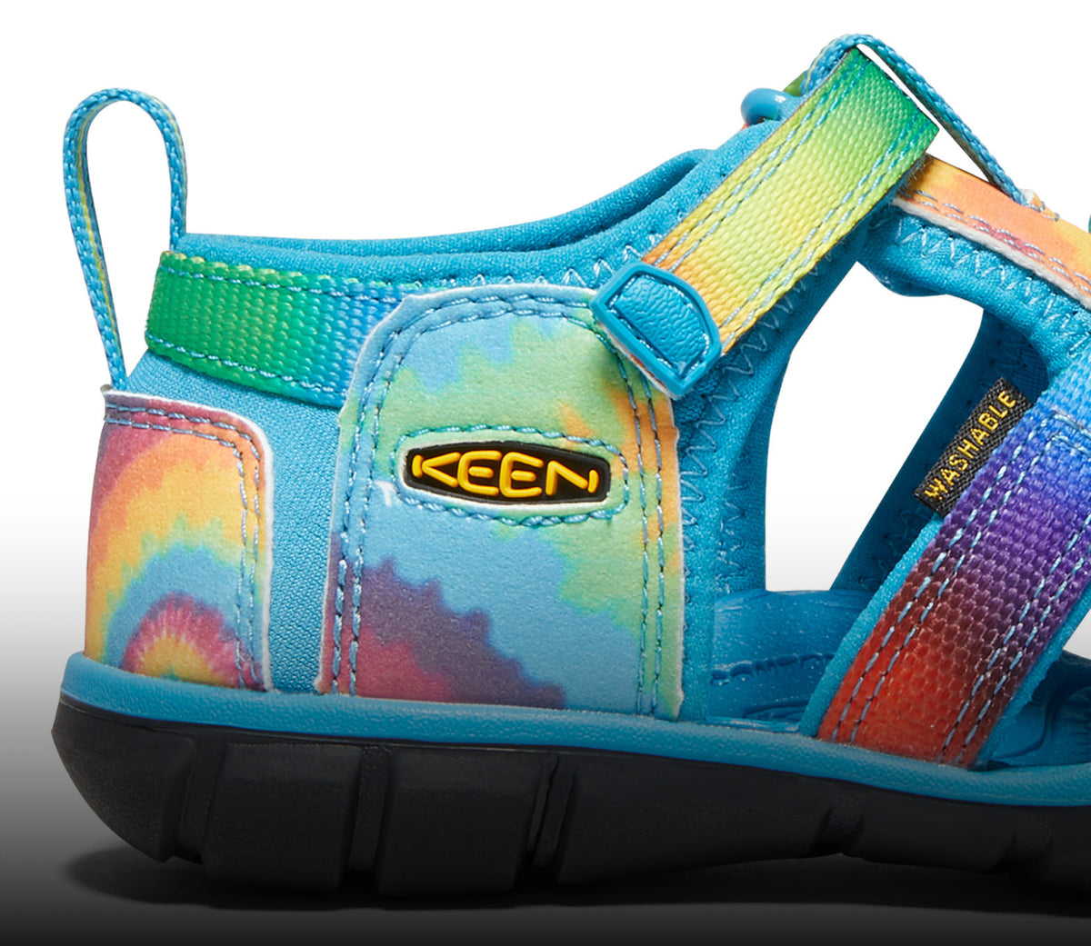 A close-up of a tie-dye Seacamp kids' sandal.