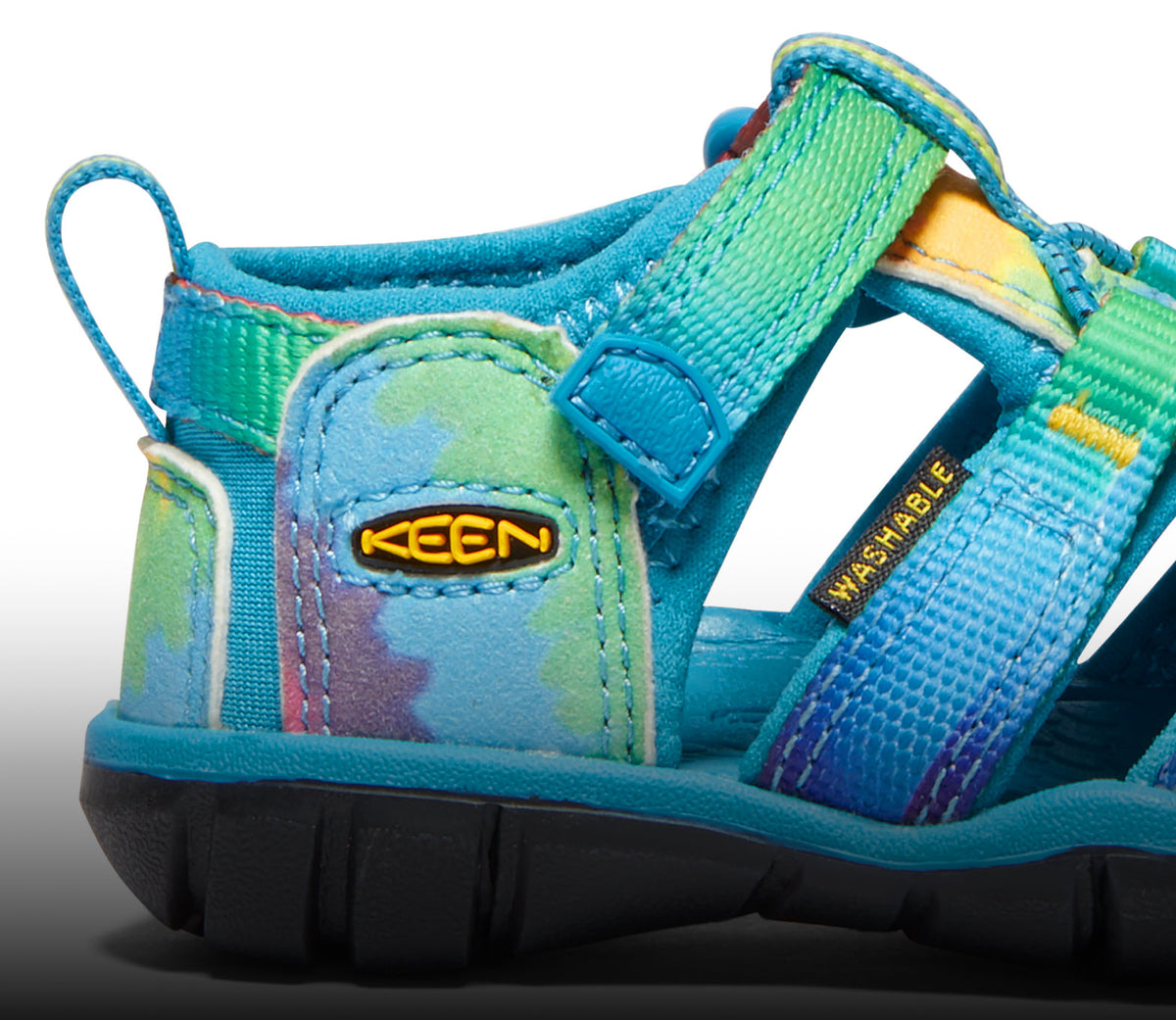 A close-up of a tie-dye Seacamp kids' sandal.