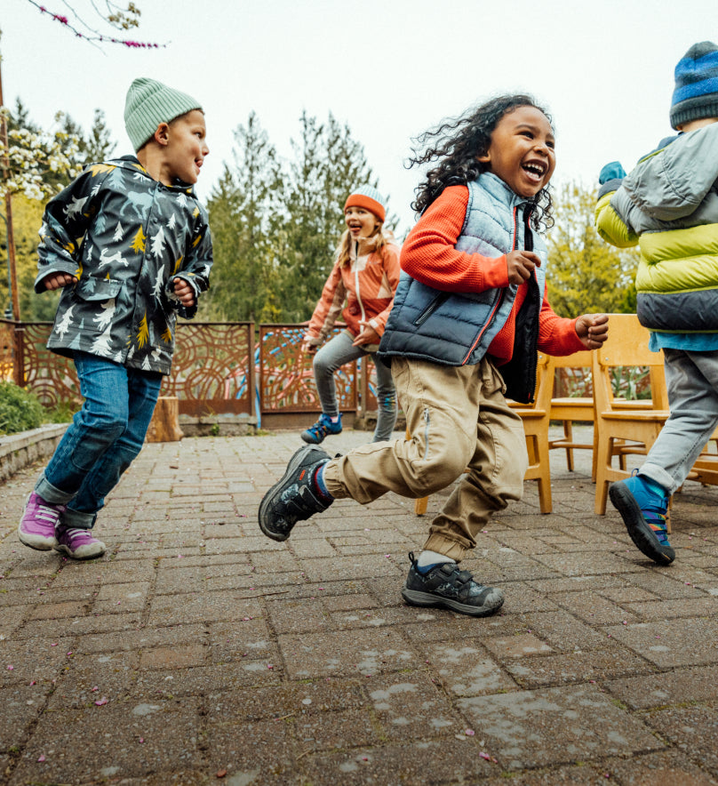 4 young kids playing musical chairs and wearing various colors of Speed Hound shoes