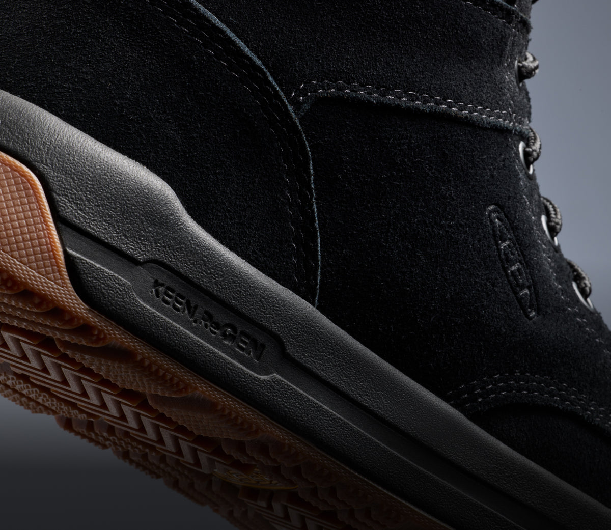 A close-up of a black Gibson work boot with KEEN.ReGEN technology.