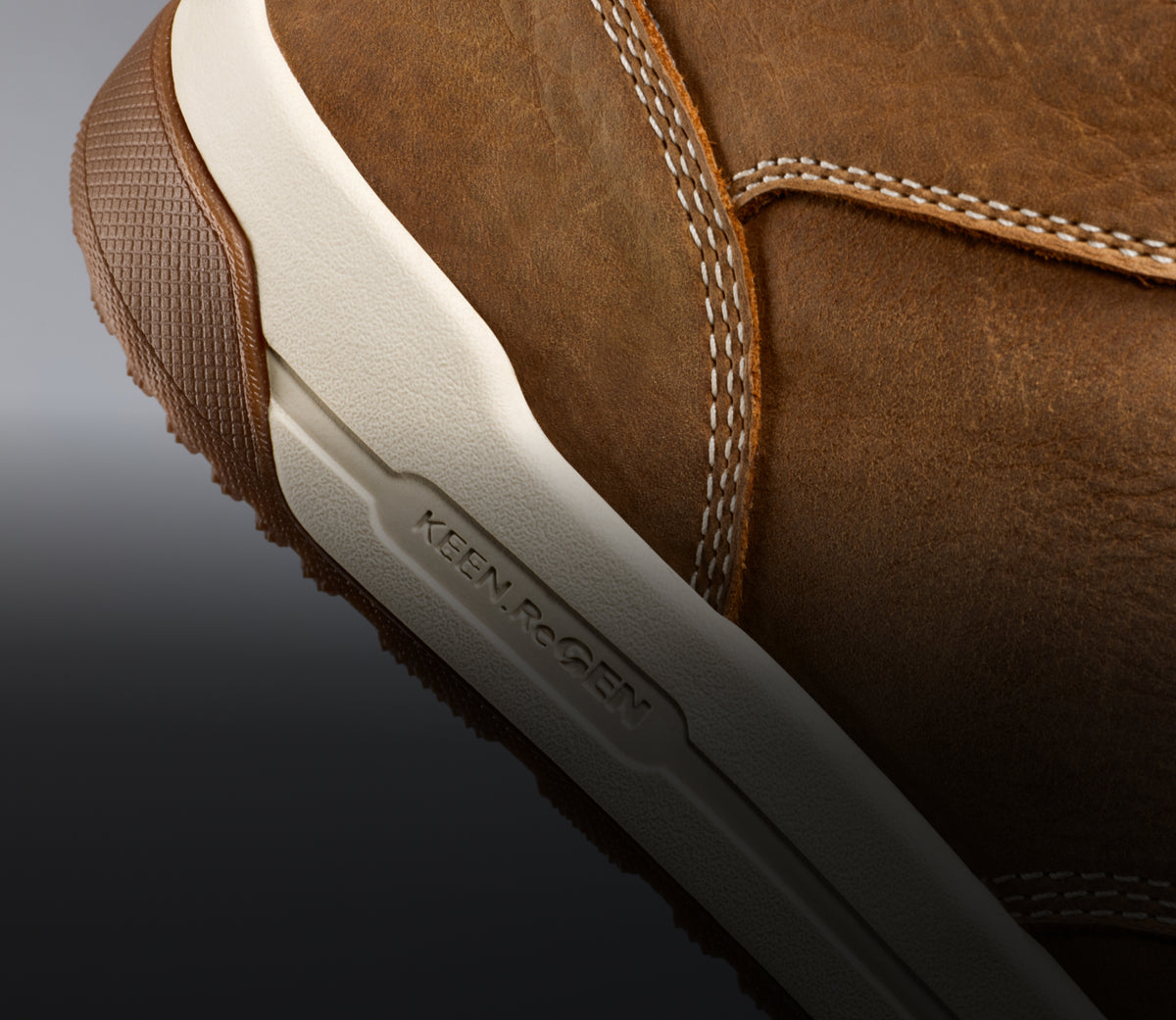 A close-up of a brown Gibson work boot with KEEN.ReGEN technology.