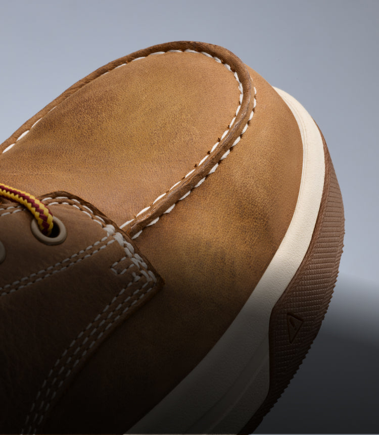 A close-up of the front of a camel-colored Gibson work boot.