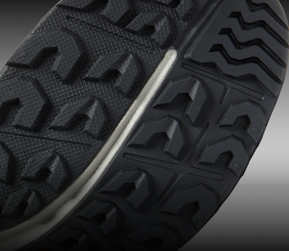 Closeup view of all-terrain tread on NXIS hiking shoe. 