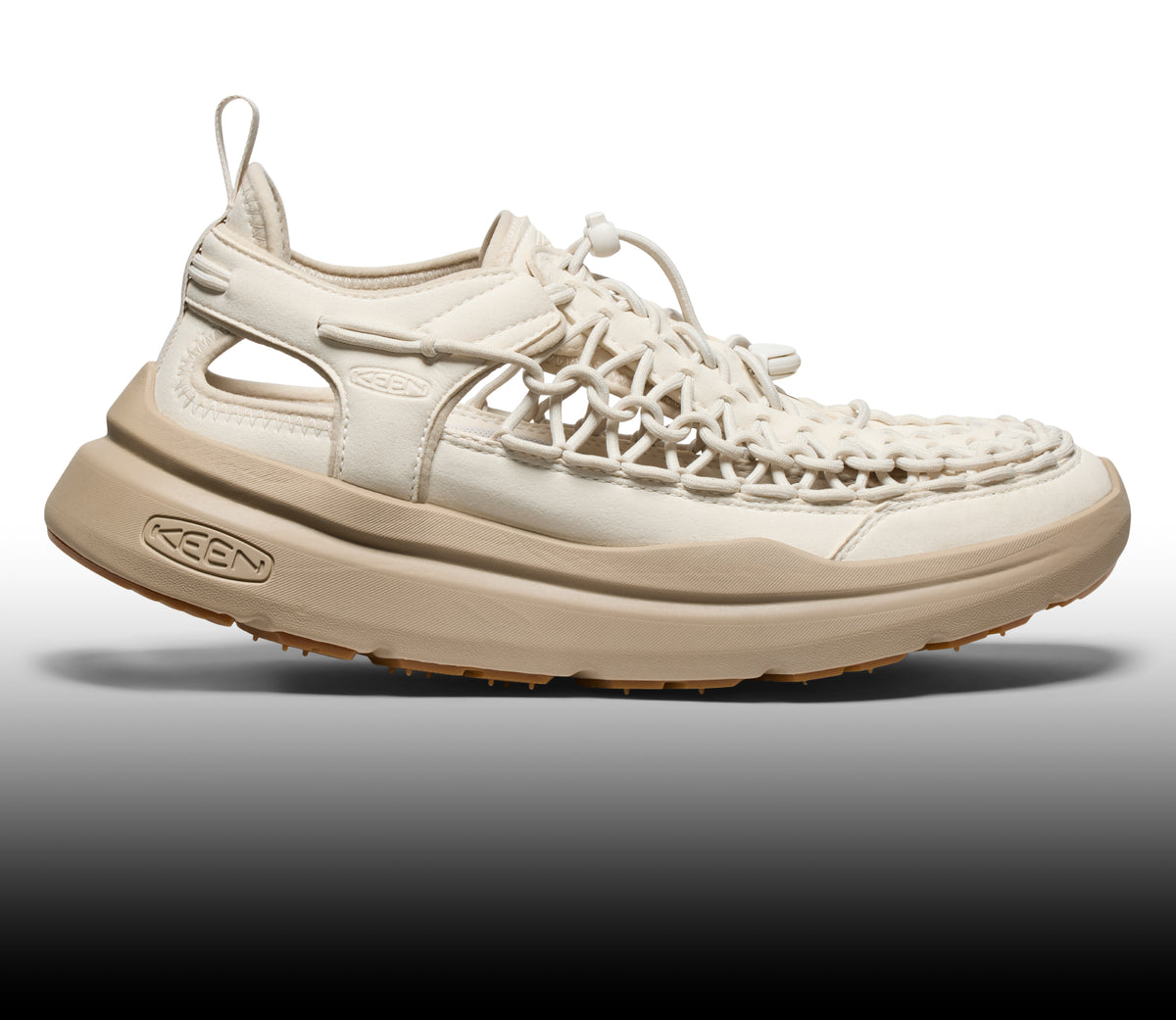Side profile of a cream-colored KEEN hybrid shoe featuring a unique woven cord upper and a chunky tan midsole.