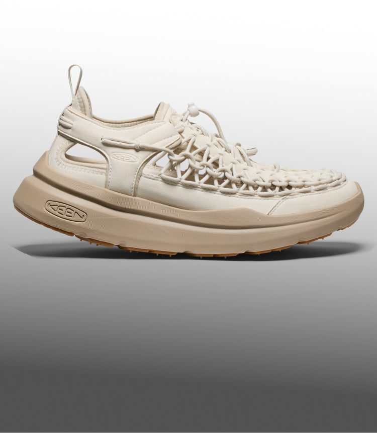 Side profile of a cream-colored KEEN hybrid shoe featuring a unique woven cord upper and a chunky tan midsole.