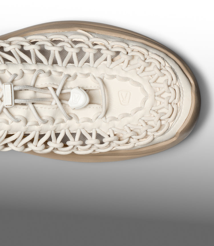 Top-down detail of a cream-colored KEEN shoe featuring an intricate woven cord design and elastic bungee laces.