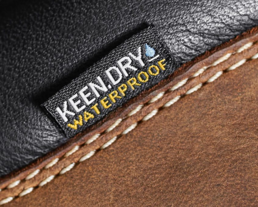 Close-up of KEEN>DRY waterproof tag on leather boot.
