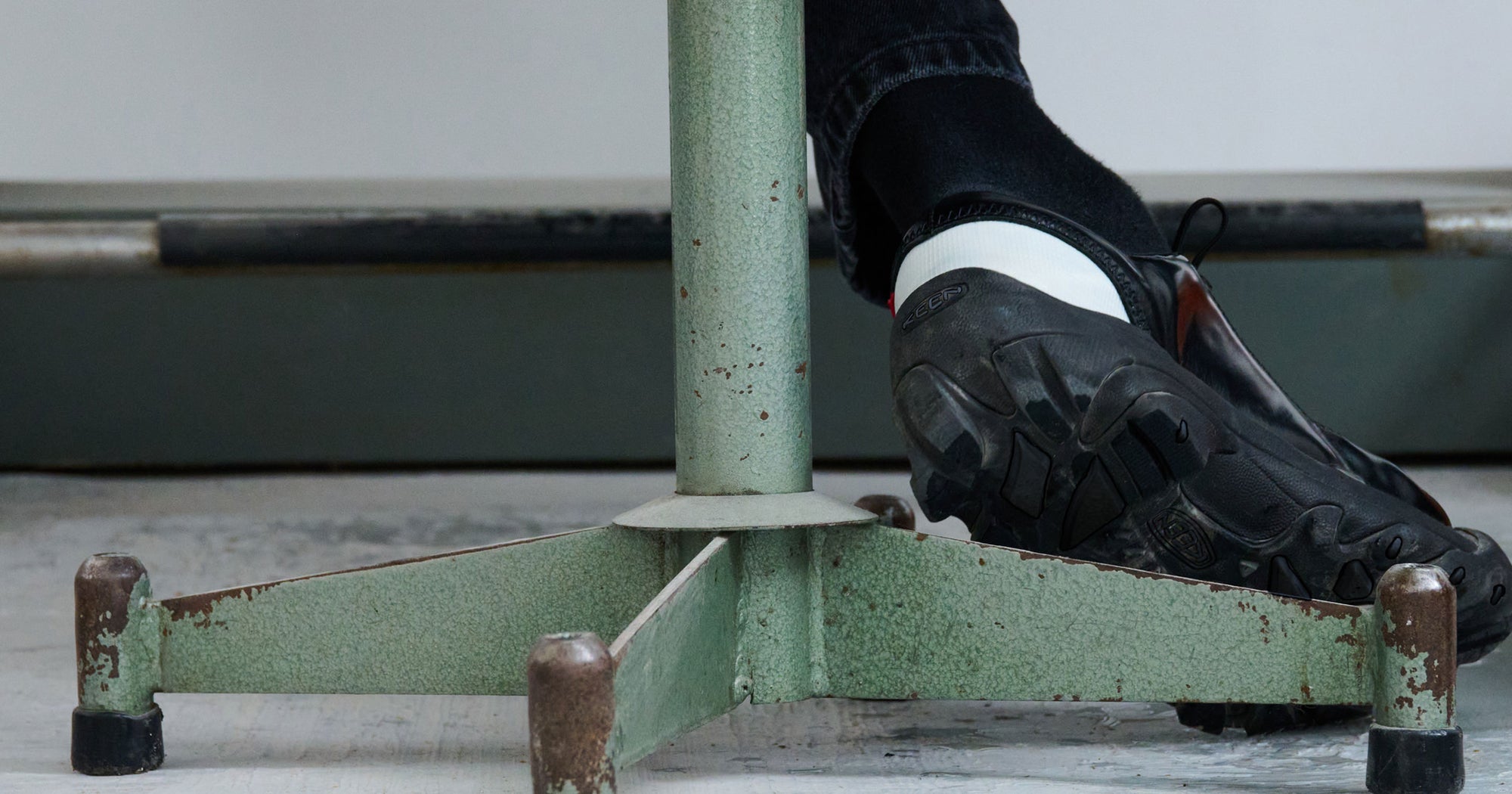 Close up of green stool base and heel of Black KEEN & Phileo collaboration Targher shoe
