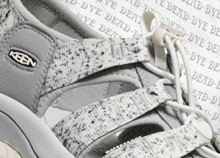 Close-up shot of KEEN x Dead Dye collaboration Newport Sandal in grey and tan with black speckles