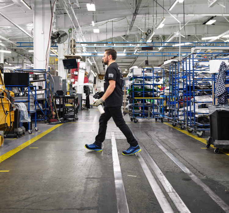 Man walking in Arvada shoes across a cement factory floor