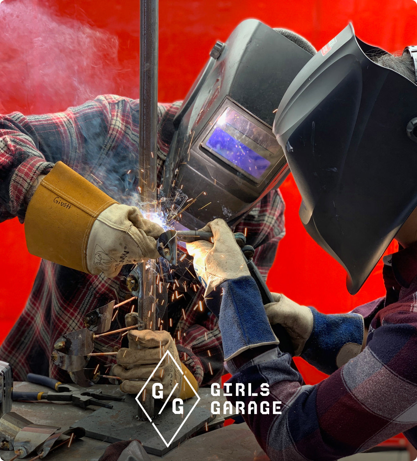 Two woman welders working on metal rod together