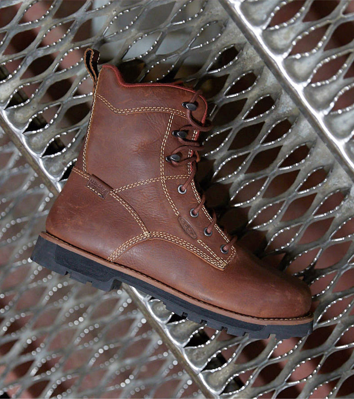 A brown KEEN boot with a black sole.
