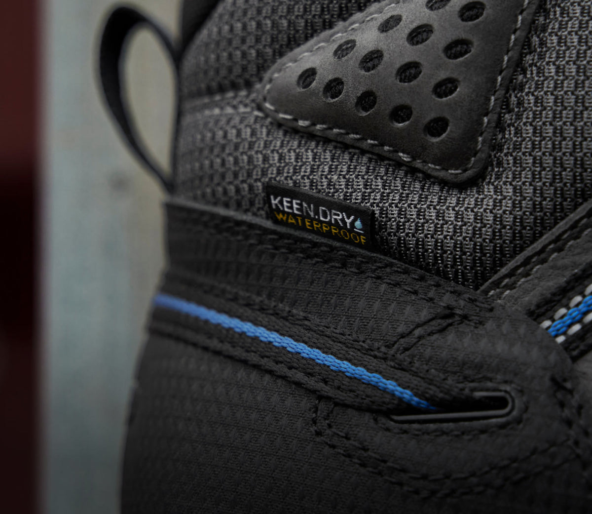 A close-up of a black KEEN work sneaker featuring KEEN.DRY waterproof material.