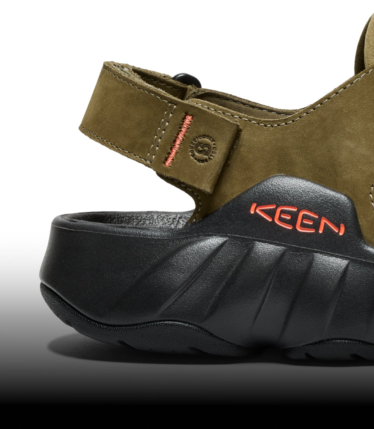 A close-up of the back strap of an olive green Hyperport Fisherman sandal.