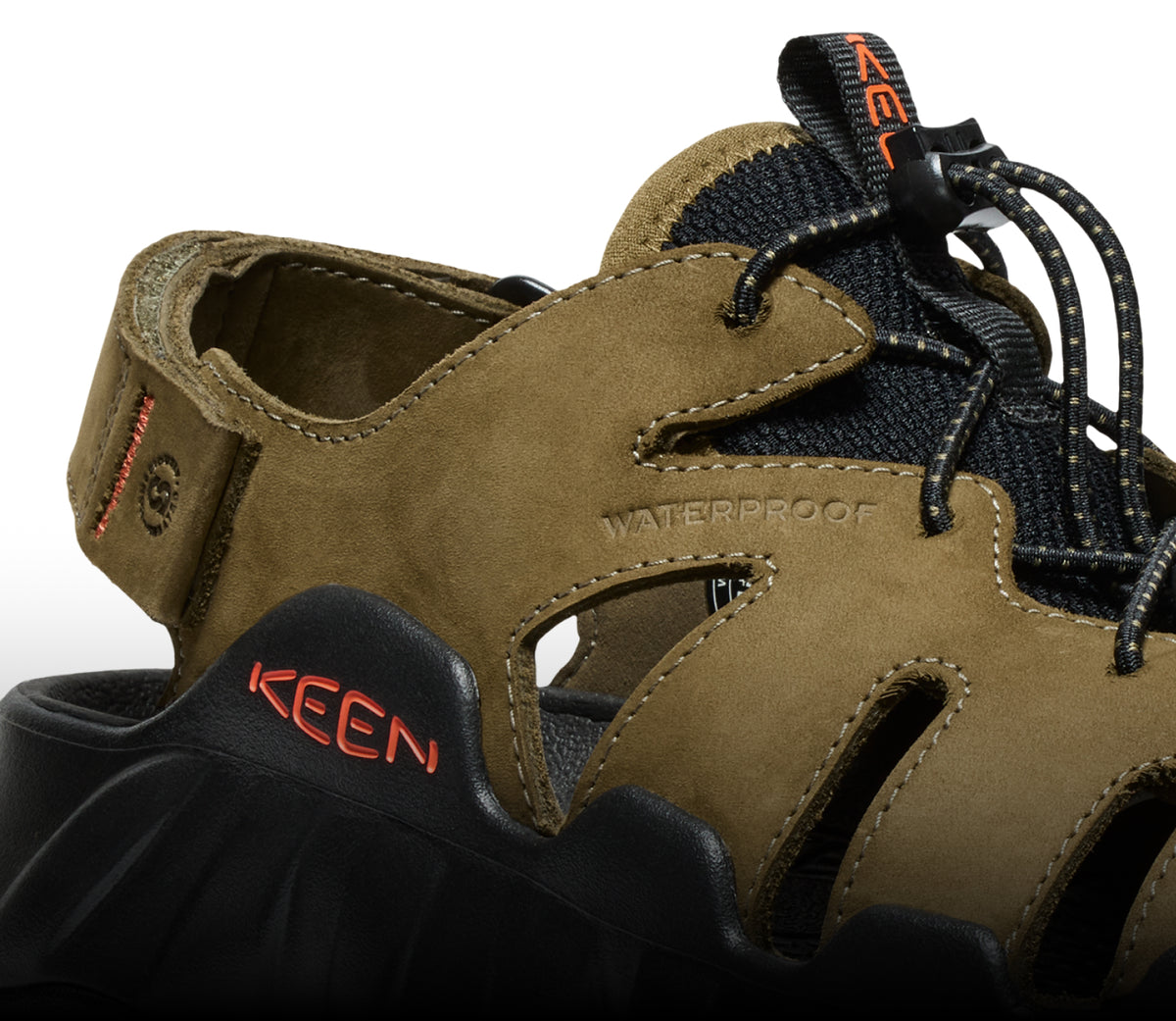 A close-up of a black and olive green KEEN sandal.