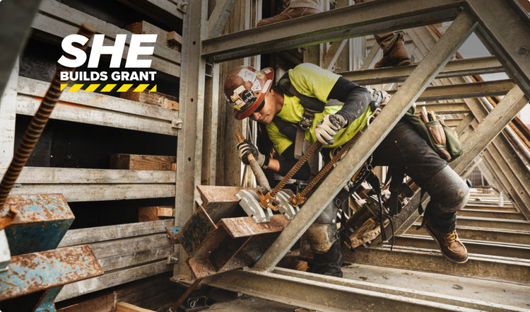 Woman in construction gear working on metal frame of building