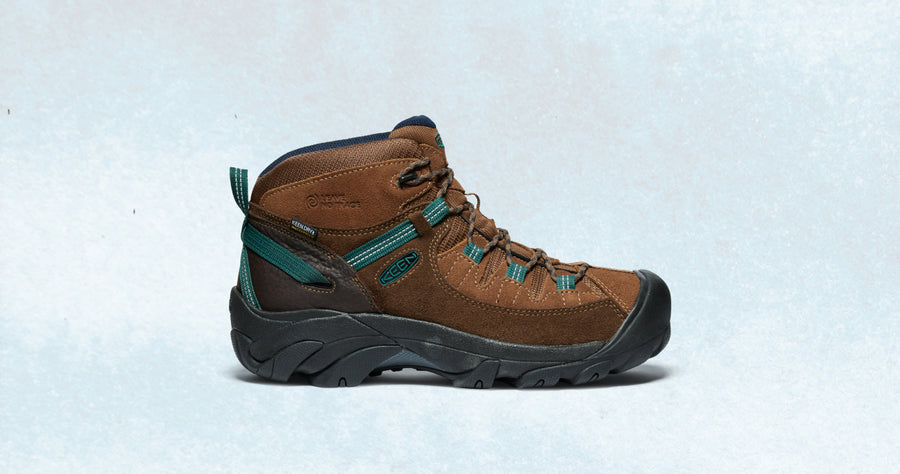 A brown Targhee hiking boot with teal accents and a black outsole.