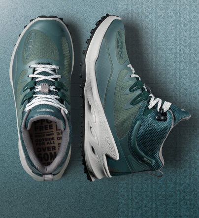 Close up of Zionic boots on teal gradient background