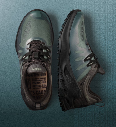 Close up of Zionic hiking shoes on teal gradient background