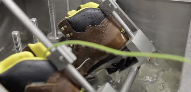 Work boot attached to machinery being tested in ice water