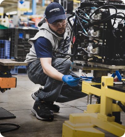A man operating machinery inside a factory.