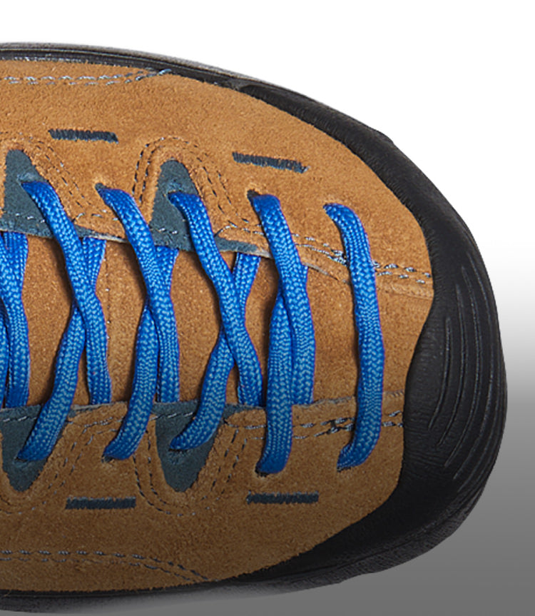 A close-up of a brown, suede Jasper shoe with blue laces and stitching.