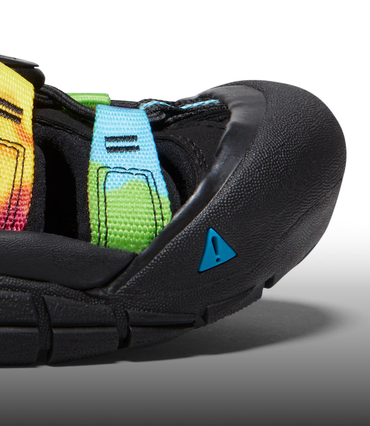 A close-up of the front of a black and tie-dye Newport sandal.