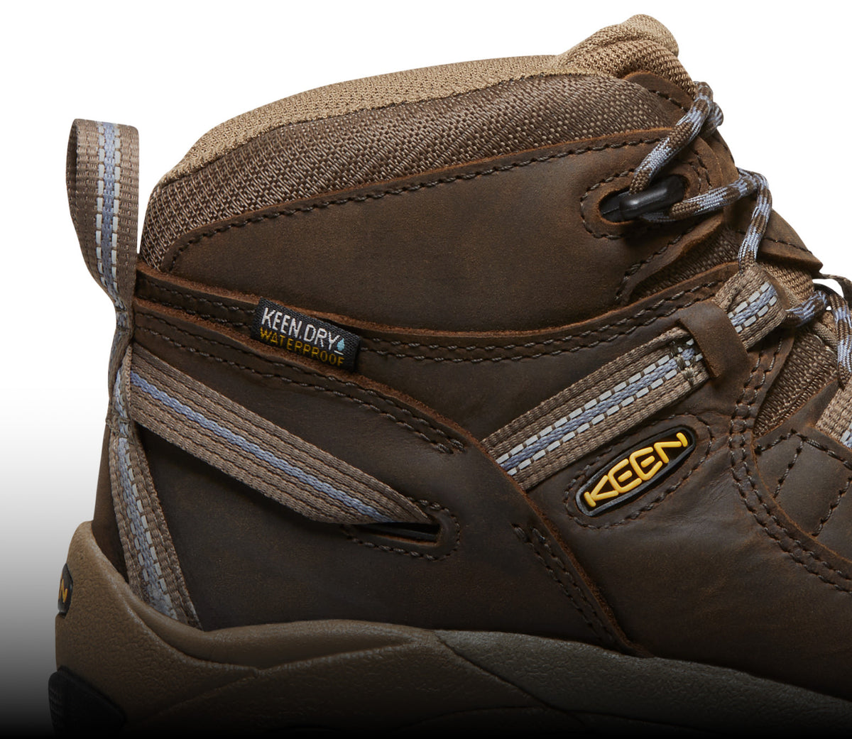 A close-up of a brown KEEN Targhee boot with light blue details.