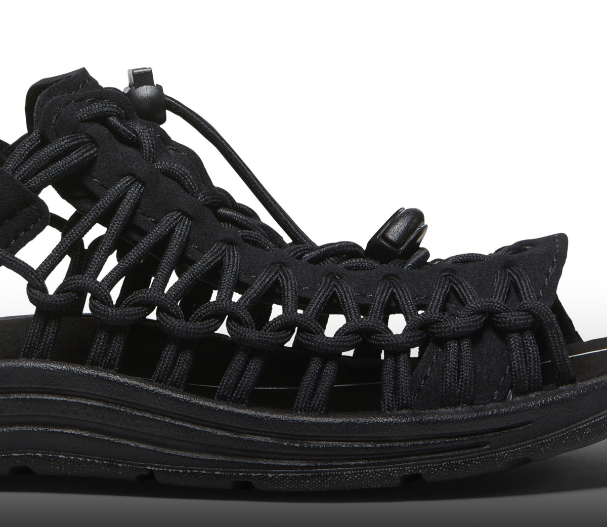 A close-up the side of a black KEEN UNEEK sandal.