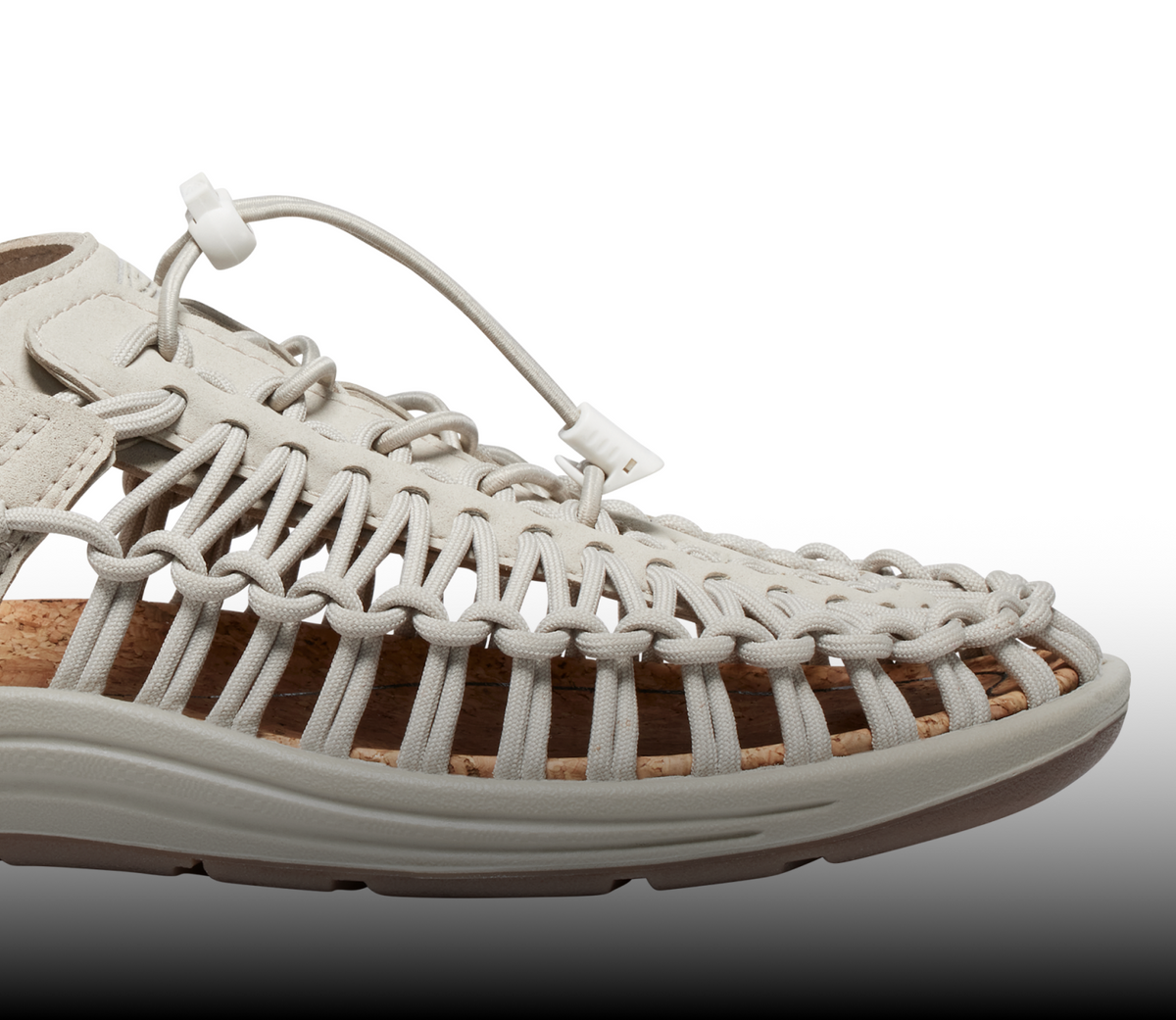 A close-up of a cream-colored KEEN UNEEK sandal.