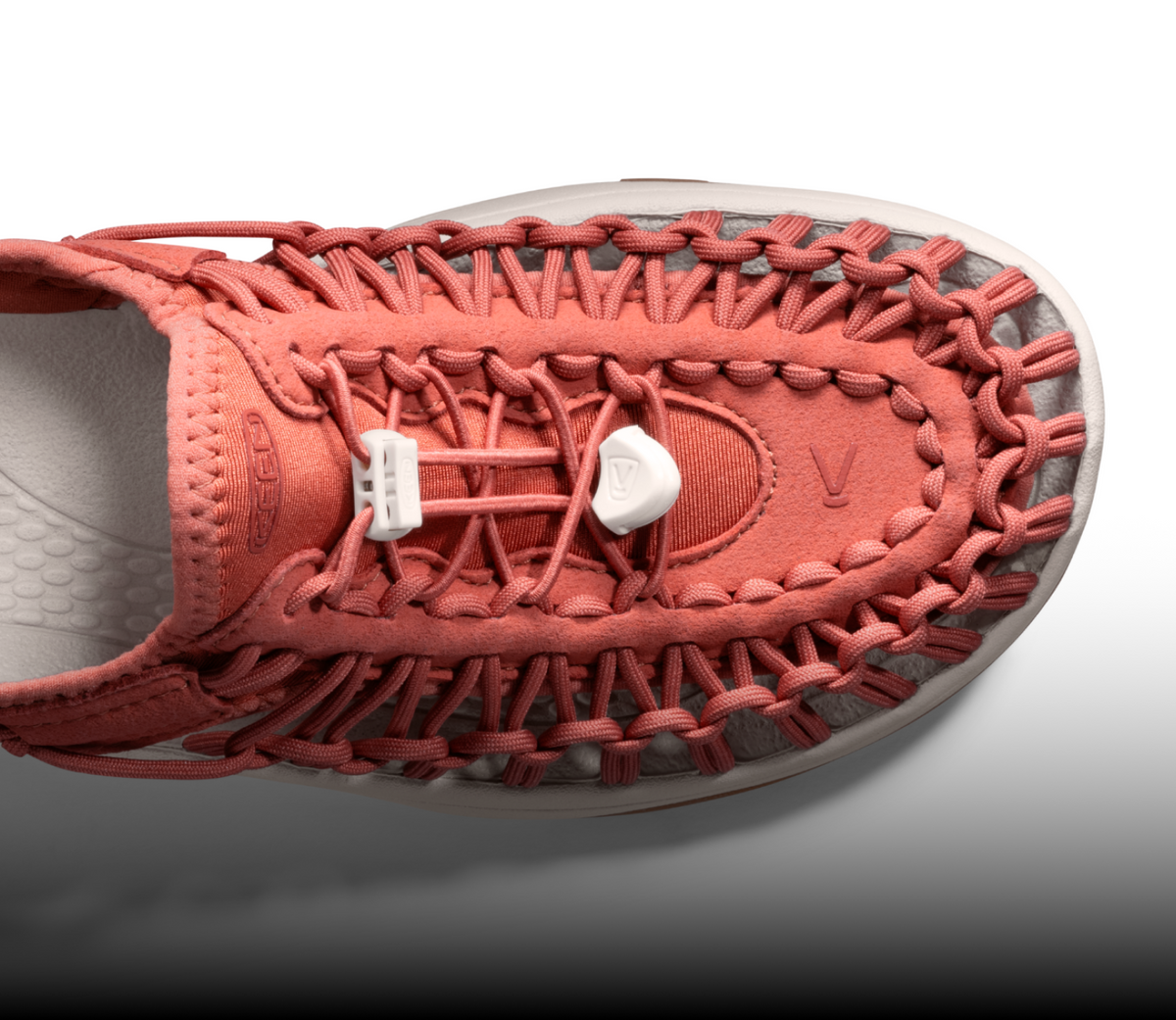 A close-up of the front/top of a coral KEEN UNEEK sandal.