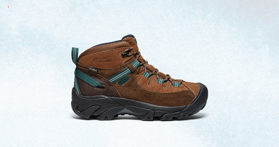 A brown Targhee hiking boot with teal accents and a black outsole.