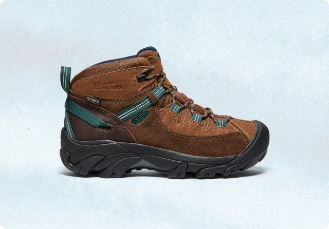 A brown Targhee hiking boot with teal accents and a black outsole.