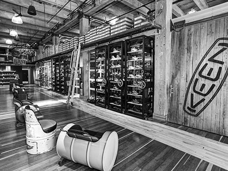 black and white view of shoe-fitting area inside the Portland Keen garage.